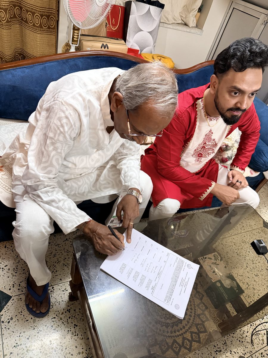 Elder and Shoumo reviewing papers together on the blue couch