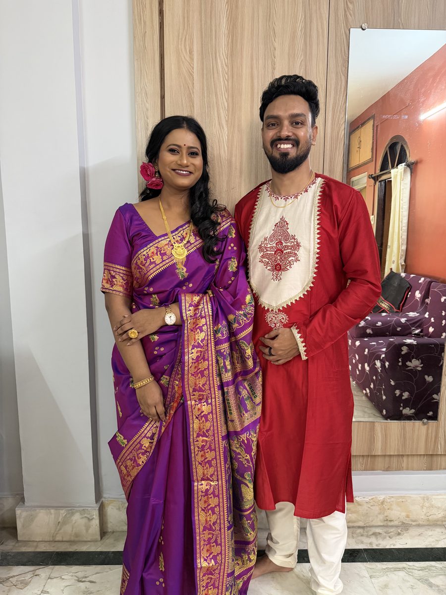 Rituparna in purple Banarasi and Shoumo in red kurta, portrait together indoors