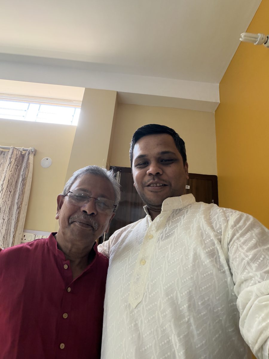 Couple with child and family members at the doorway in traditional attire