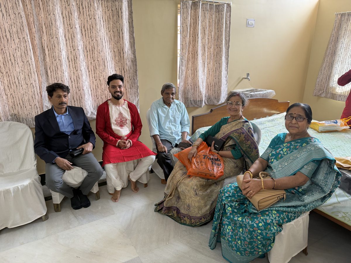 Elder man and younger man in traditional white attire