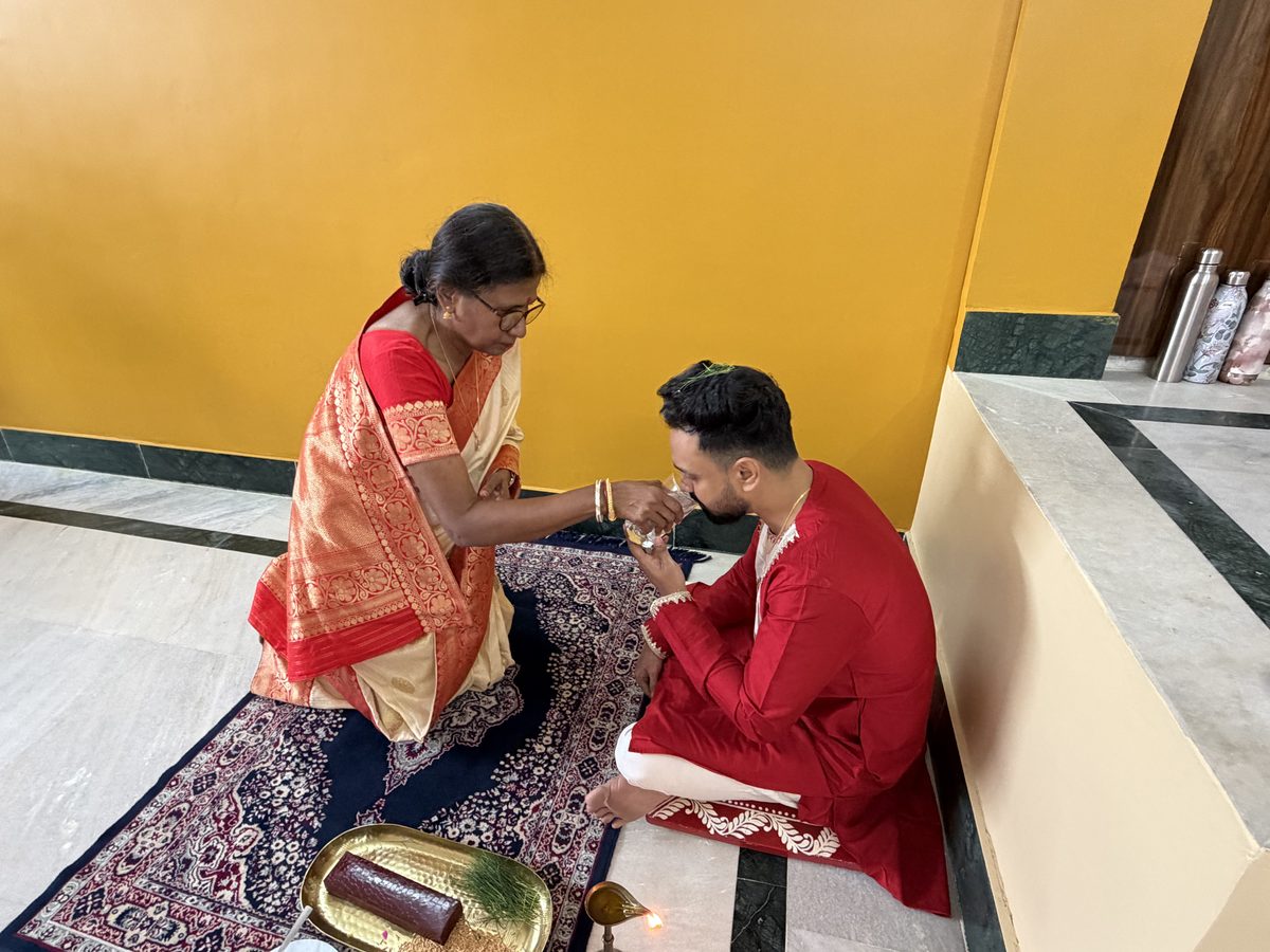 KumKum Ma lovingly feeding Shoumo sweets during the ceremony