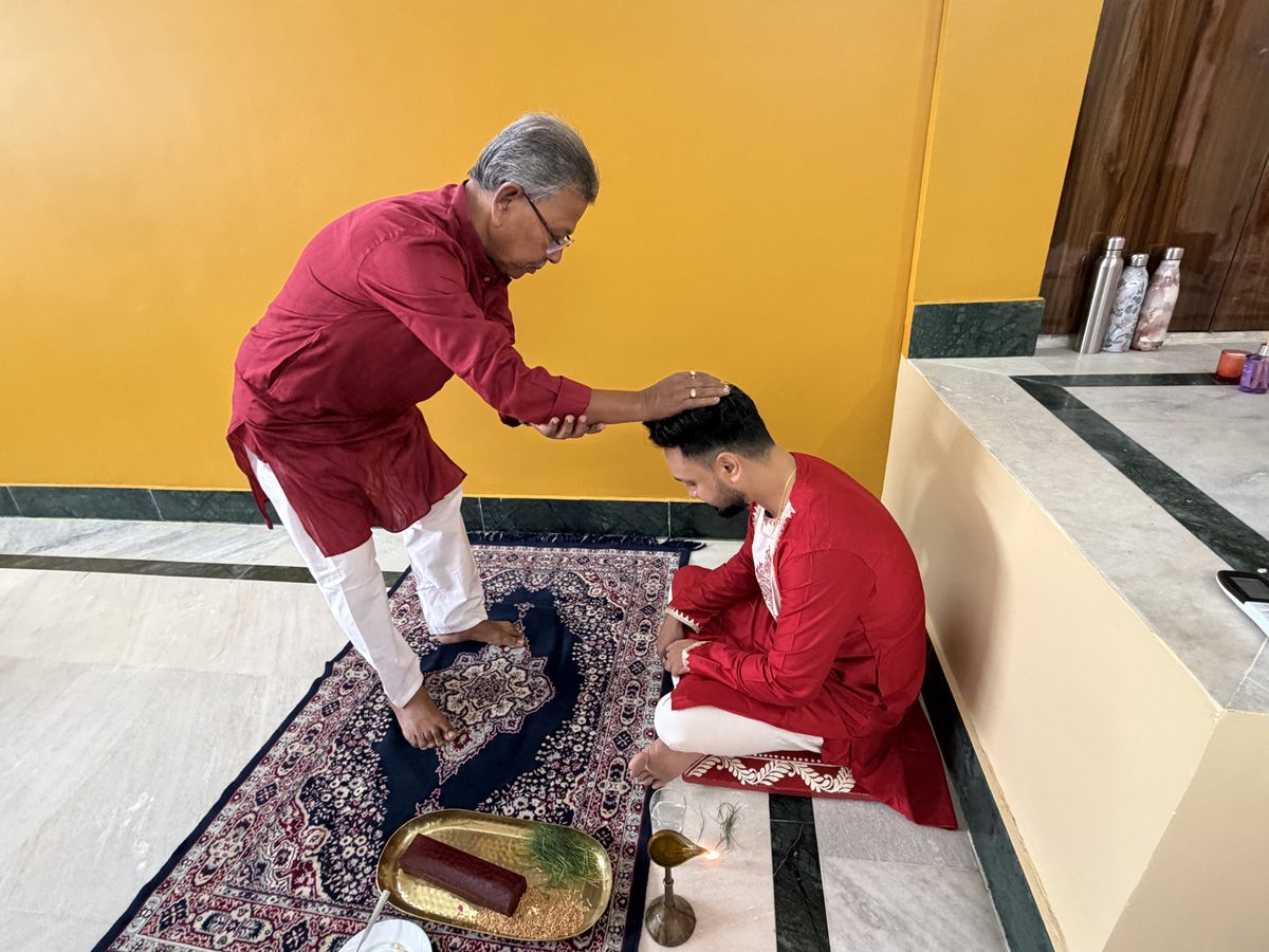 Rituparna and Shoumo reviewing documents together on the couch