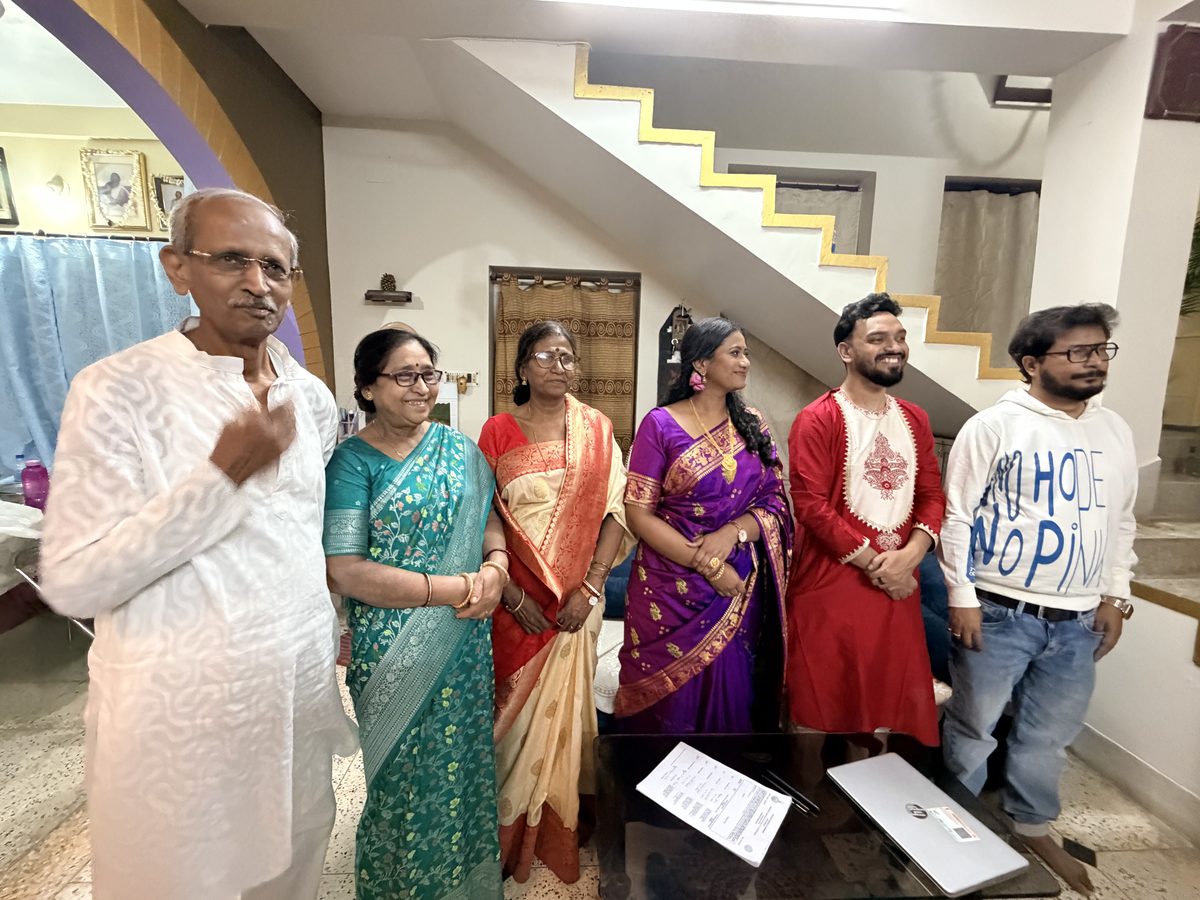 Six family members in formal wedding attire posing together