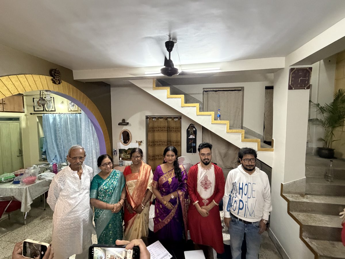 Six family members in wedding clothes standing together at home