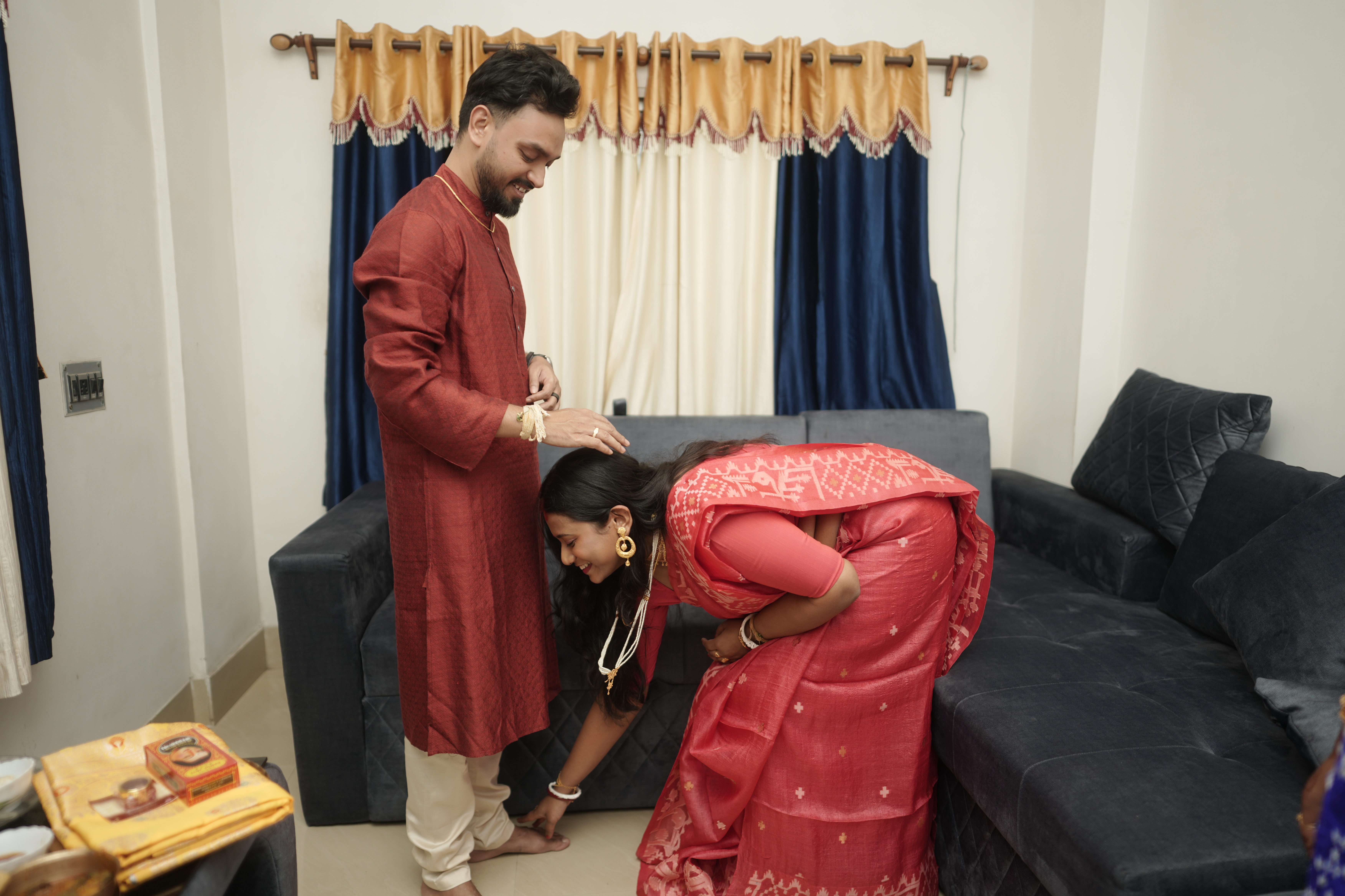 Rituparna bowing to touch Shoumo's feet in a tender pranam gesture