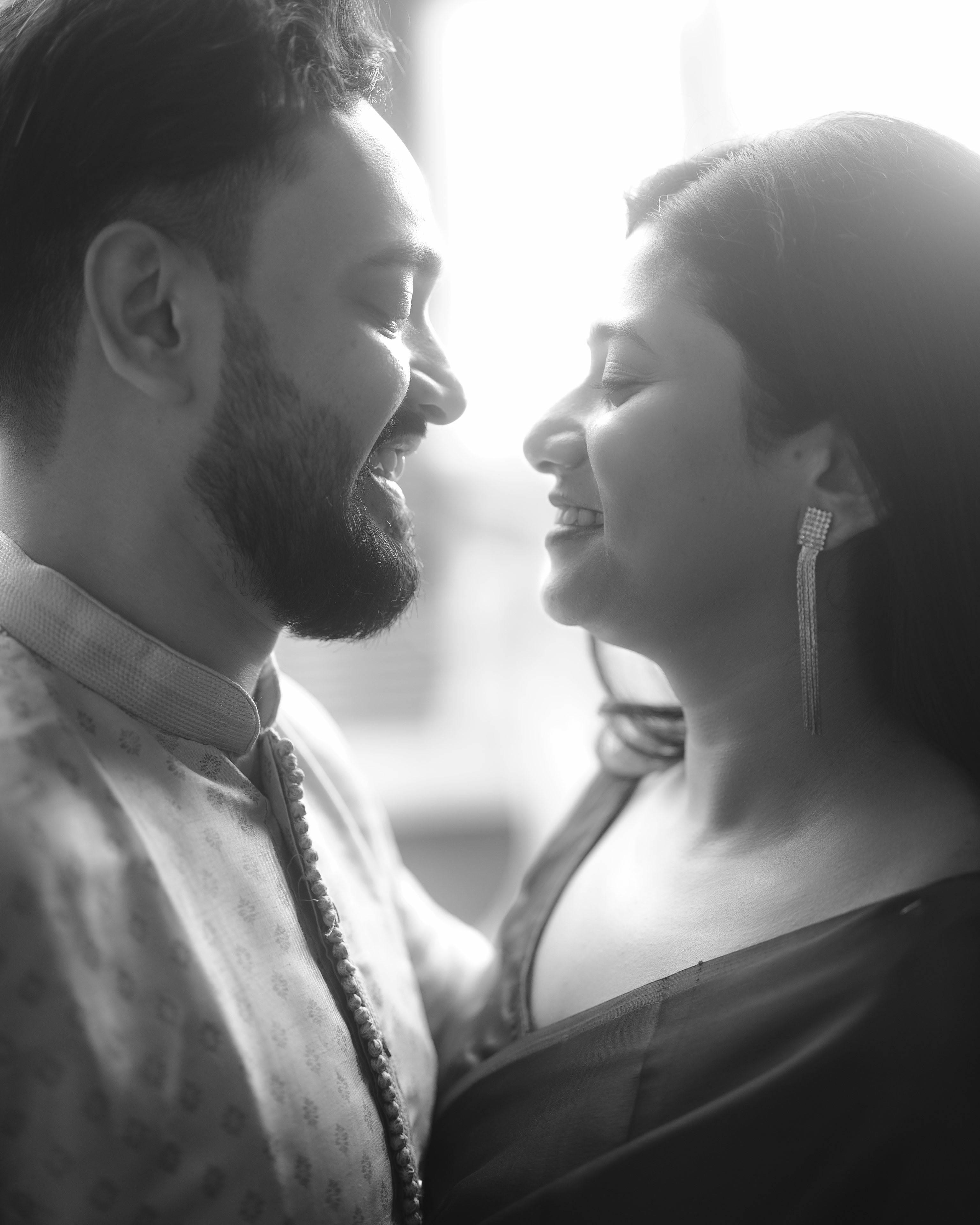 Black and white close-up of the couple with ethereal backlighting