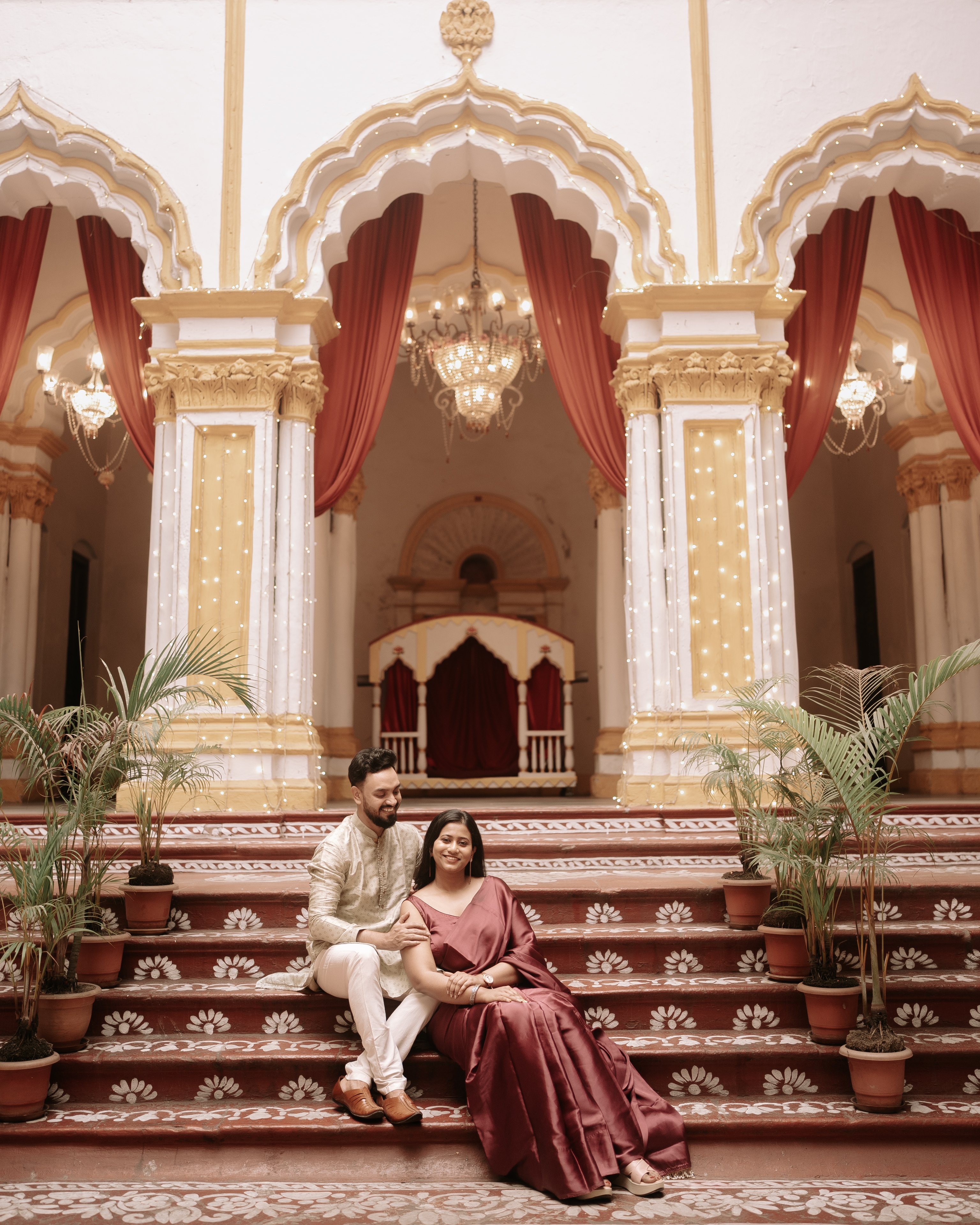 Rituparna and Shoumo together on the palace steps with lotus motifs