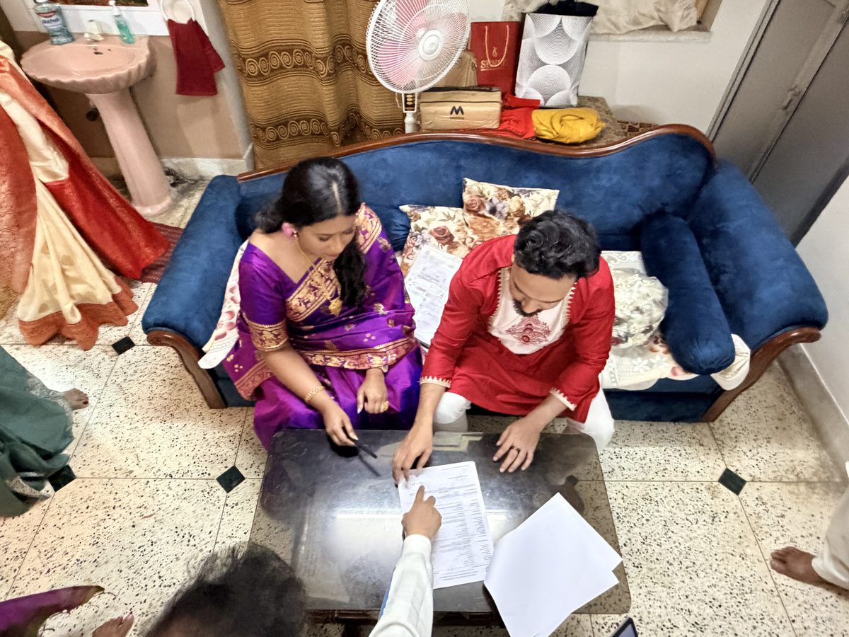 Rituparna and Shoumo reviewing documents together on the couch