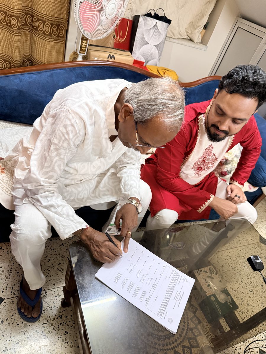 Rituparna and Shoumo smiling at each other, wearing garlands